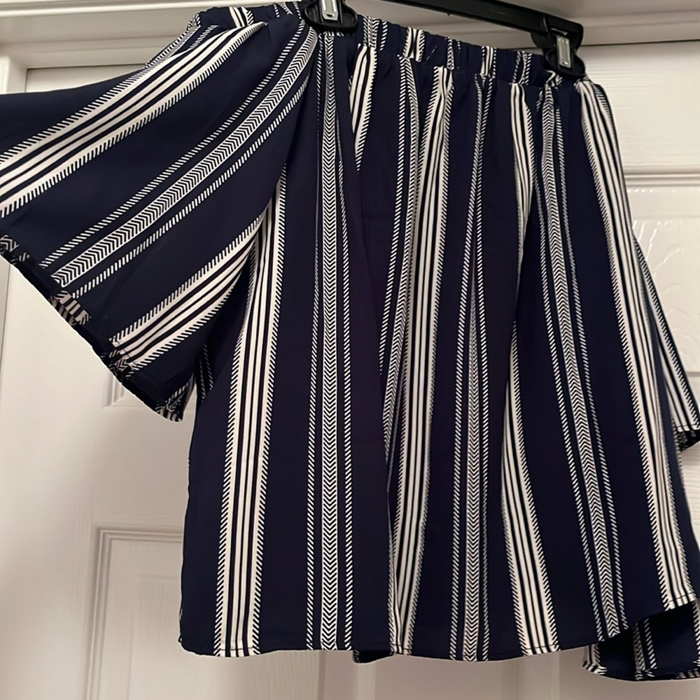 Off the shoulder blouse with navy blue with white stripes.